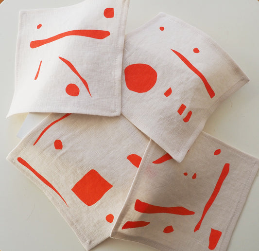 Printed linen cocktail napkin in orange abstract art. Home decor handmade in Canada 